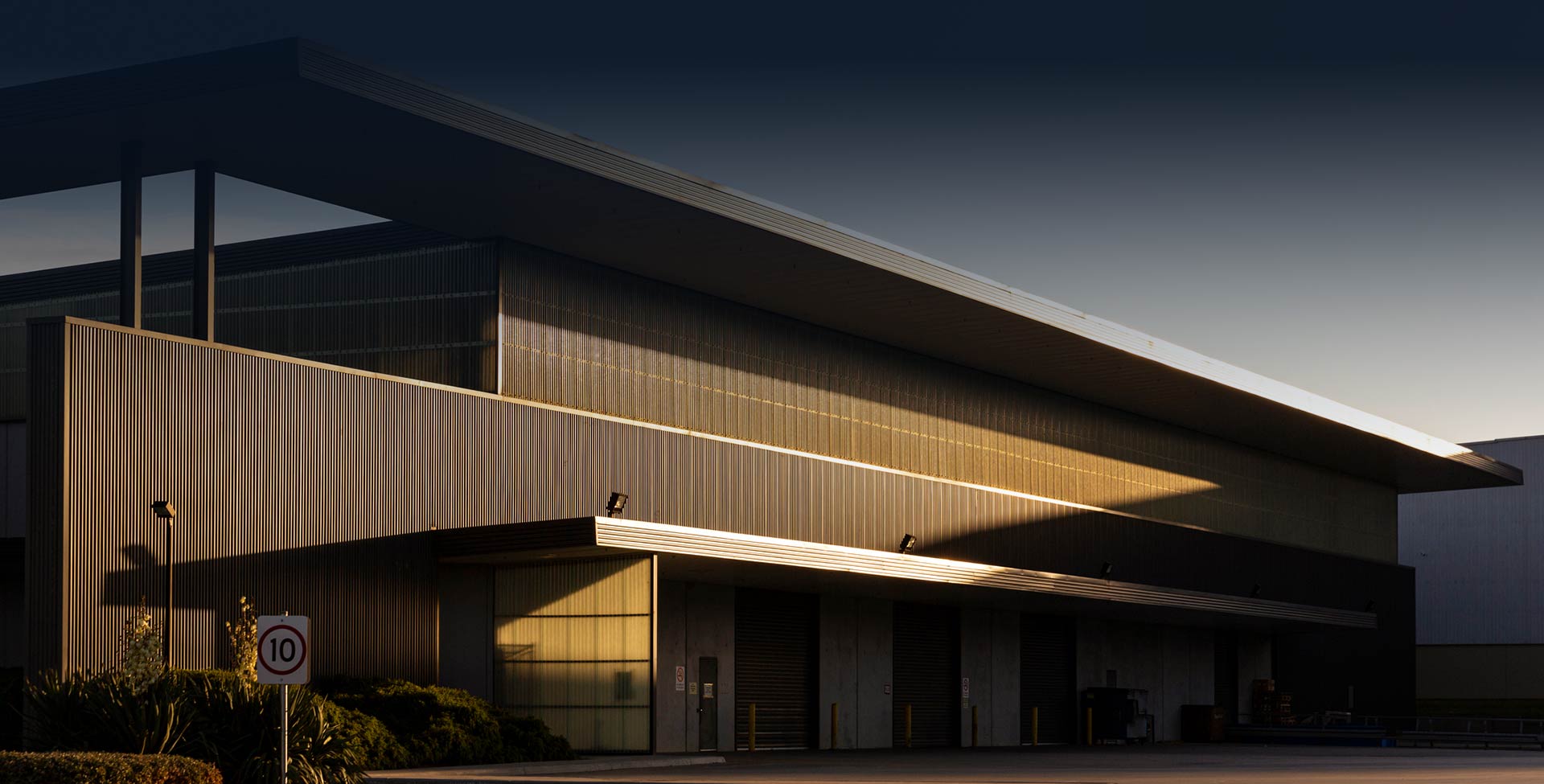 Modern warehouse exterior during afternoon dusk sunlight